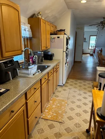 a kitchen with sink cabinets and utility