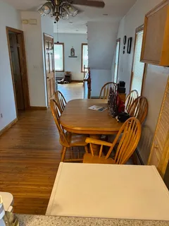 a dining room with furniture and wooden floor