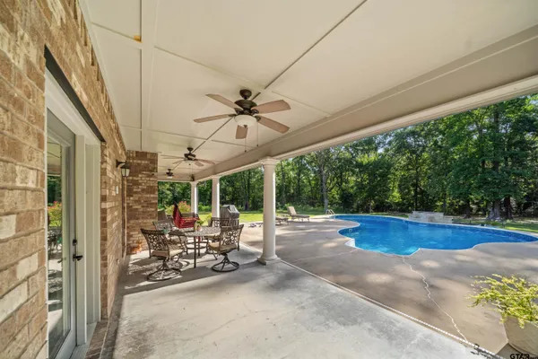 a view of a patio with table and chairs and potted plants