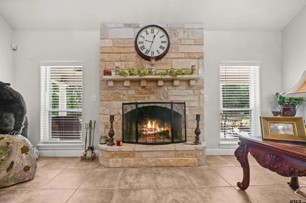 a living room with furniture a clock and a fireplace