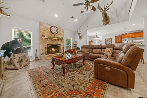 a living room with furniture a fireplace and a chandelier