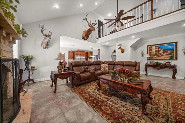 a living room with furniture a rug and a chandelier