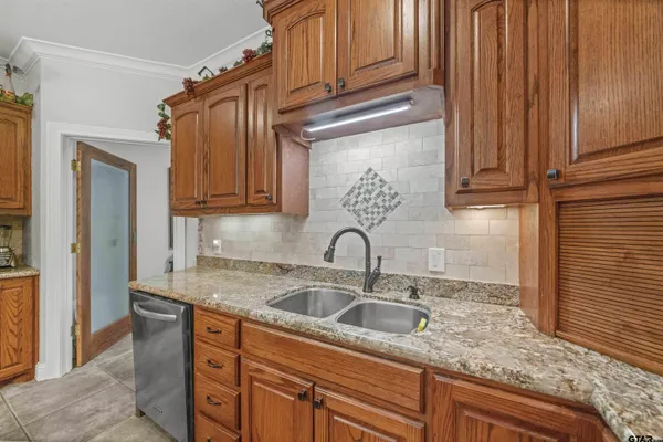 a kitchen with stainless steel appliances granite countertop a sink and cabinets