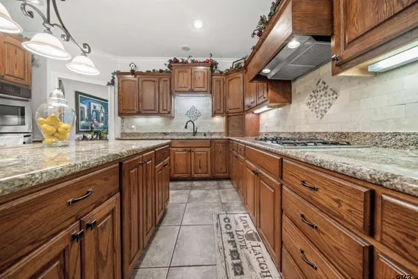 a kitchen with stainless steel appliances granite countertop a sink and cabinets