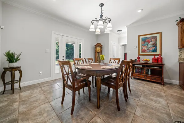 a view of a dining room with furniture and a chandelier