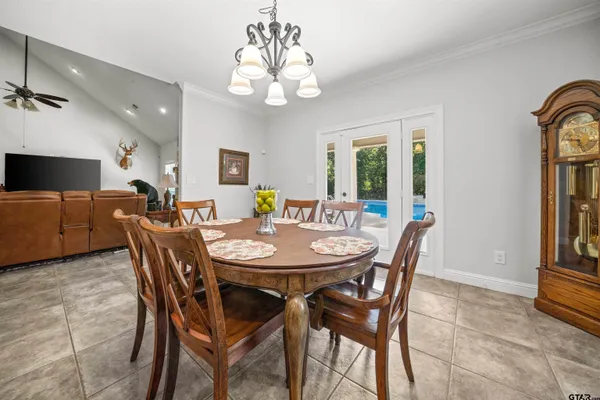 a view of a dining room with furniture and a chandelier