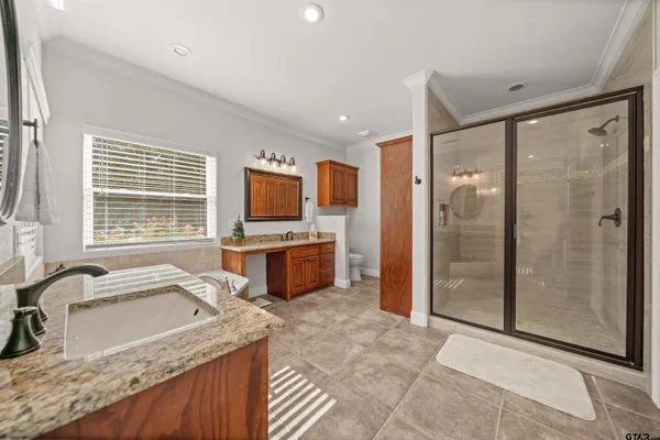 a kitchen with granite countertop a sink and a refrigerator