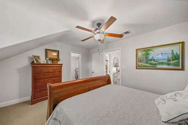 a bedroom with a bed and a dresser in it