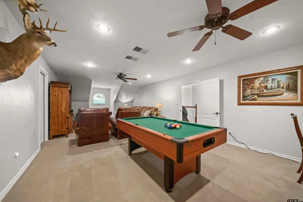 a room with pool table and windows