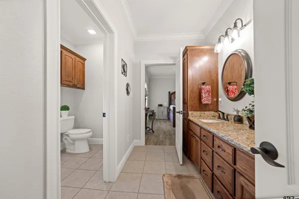 a bathroom with a double vanity sink mirror and toilet