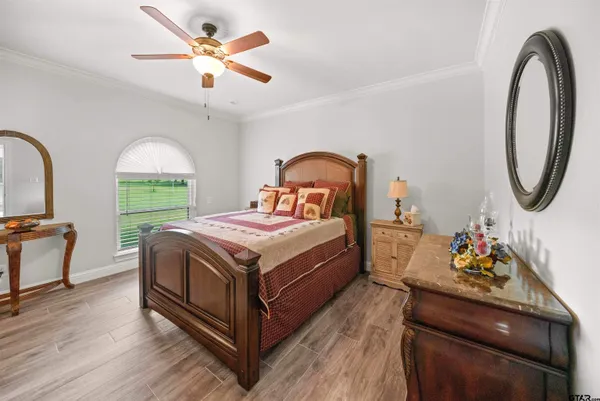 a bedroom with a bed and a chandelier