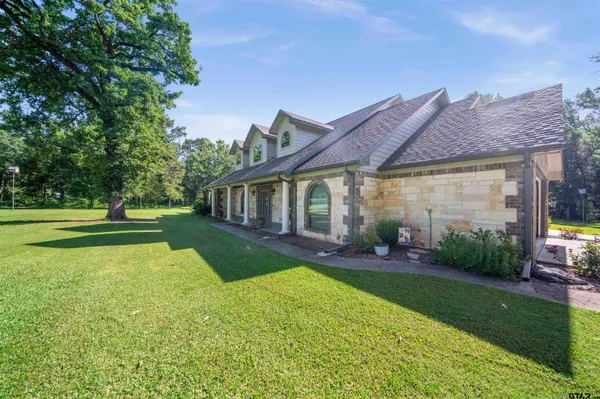 a view of a house with a backyard and a patio