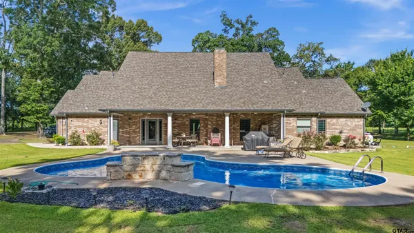 a aerial view of a house with swimming pool garden and patio