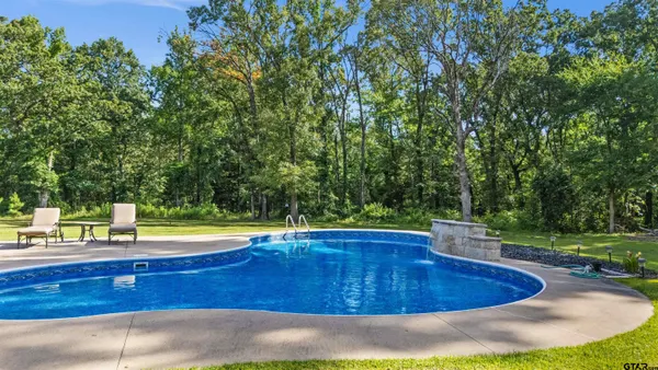 a view of a swimming pool with a yard