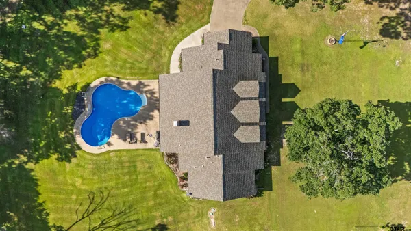 a view of a multi story residential apartment building with a yard and swimming pool