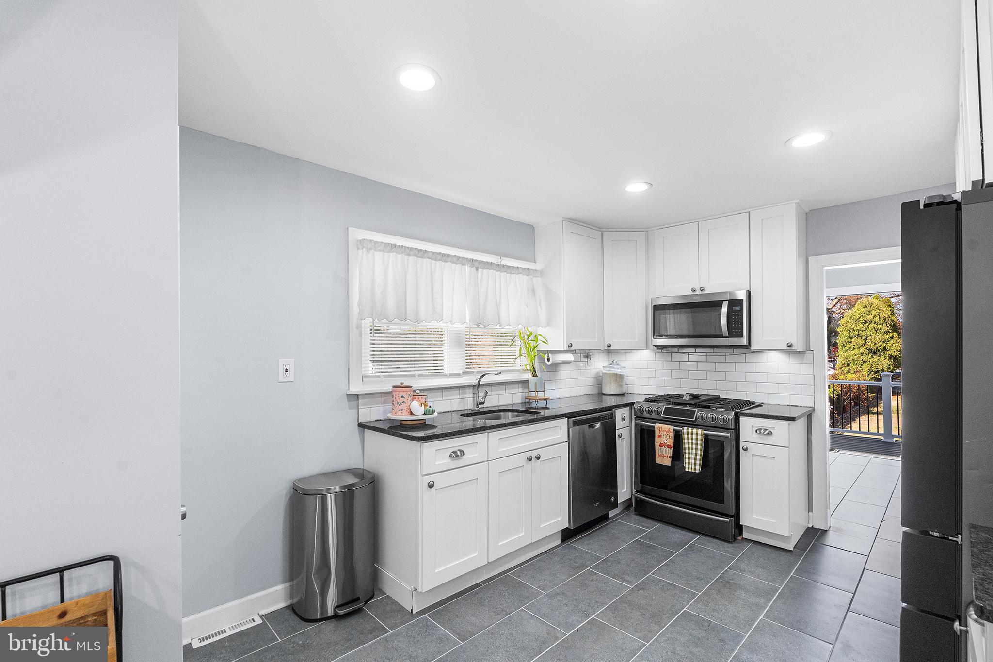 14 Nicholson Road West Collingswood Heights, NJ 08059 - Photo 22 of 50 a kitchen with stainless steel appliances granite countertop a sink and stove top oven