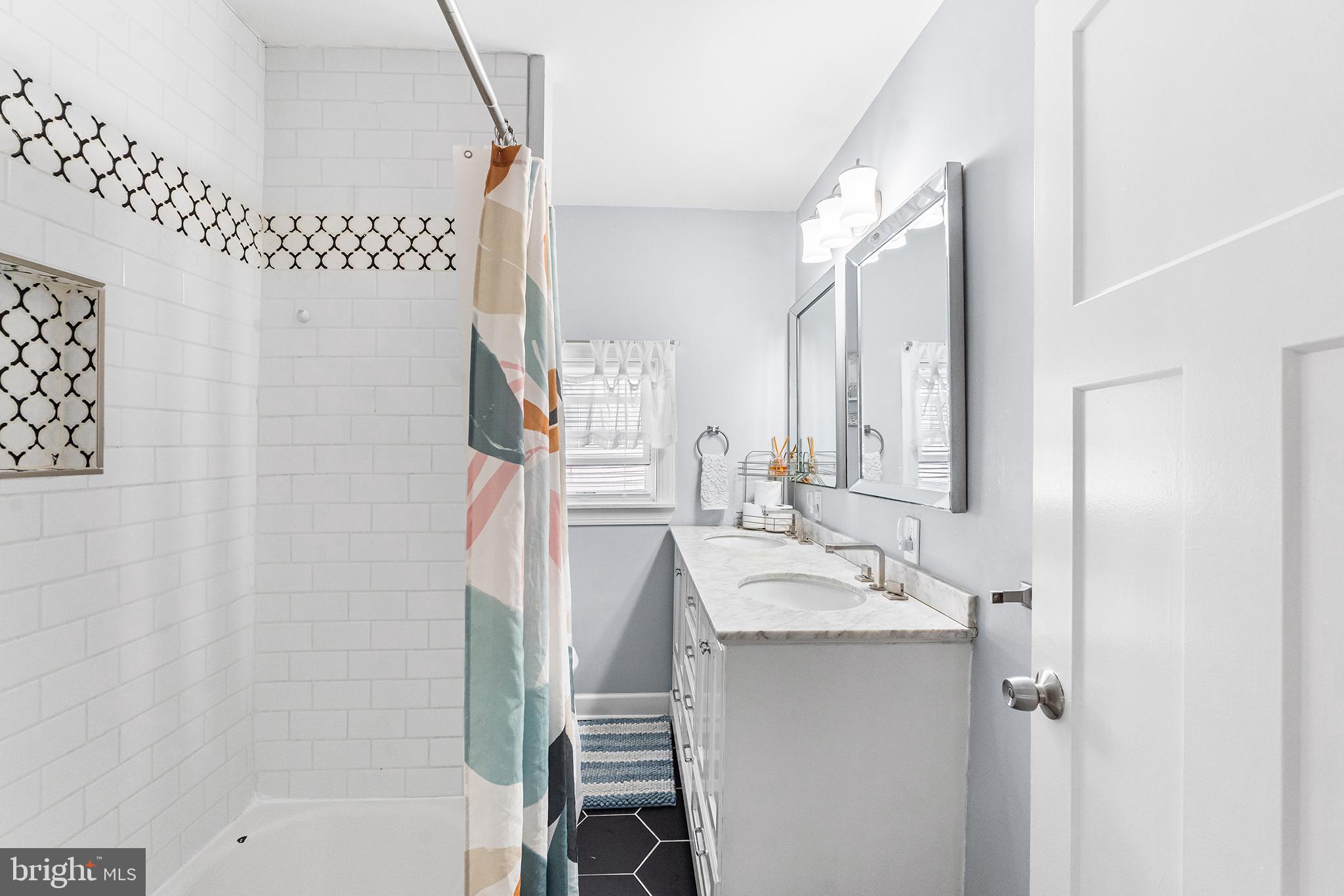 14 Nicholson Road West Collingswood Heights, NJ 08059 - Photo 38 of 50 a bathroom with a sink a mirror and a bathtub