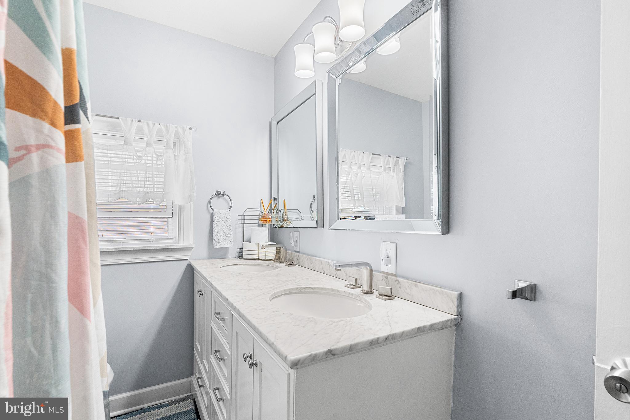 14 Nicholson Road West Collingswood Heights, NJ 08059 - Photo 39 of 50 a bathroom with a sink and a mirror