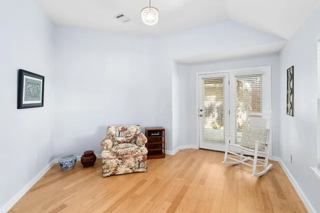 a room with wooden floor and gym equipment