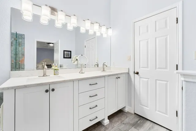 a bathroom with a double vanity sink mirror and