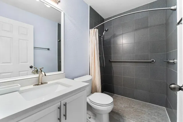 a bathroom with a sink toilet and shower