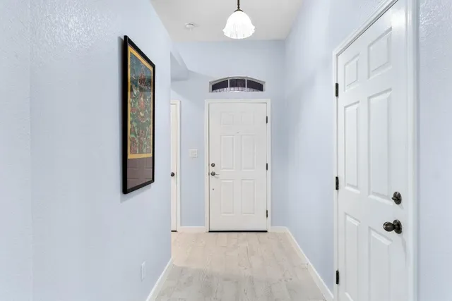 a view of a hallway with wooden floor