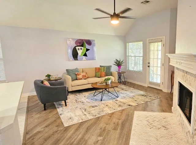 a living room with furniture and a fireplace