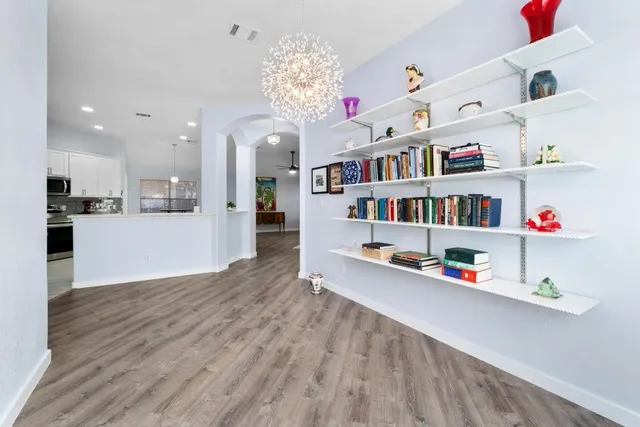 a living room with furniture and a book shelf