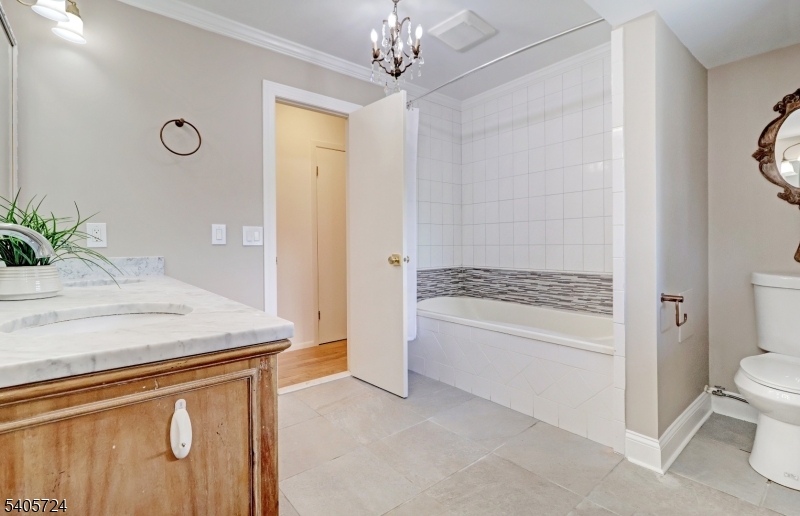 250 Ridgedale Avenue, Unit 4 Florham Park, NJ 07932 - Photo 16 of 24 a bathroom with a granite countertop sink a toilet and a tub