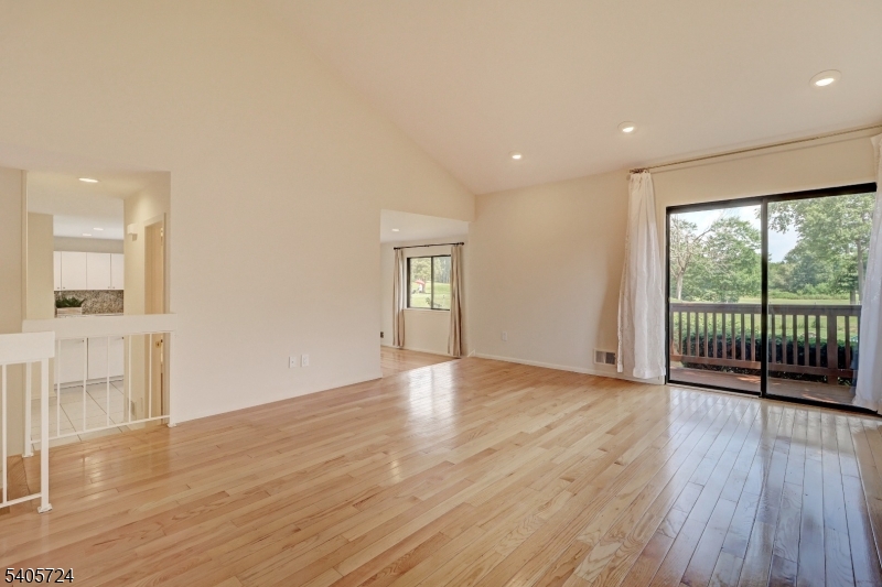 250 Ridgedale Avenue, Unit 4 Florham Park, NJ 07932 - Photo 5 of 24 a view of an empty room with wooden floor and a window