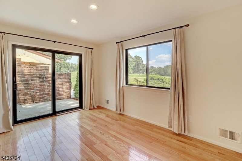 250 Ridgedale Avenue, Unit 4 Florham Park, NJ 07932 - Photo 7 of 24 a view of an empty room with wooden floor and a window