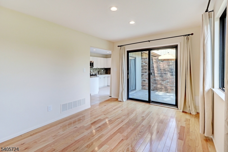 250 Ridgedale Avenue, Unit 4 Florham Park, NJ 07932 - Photo 8 of 24 a view of an empty room with wooden floor and a window
