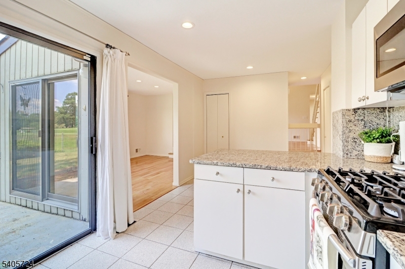 250 Ridgedale Avenue, Unit 4 Florham Park, NJ 07932 - Photo 10 of 24 a bathroom with a granite countertop sink a mirror and a shower