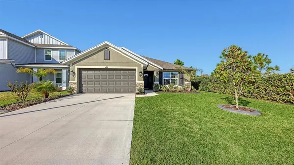 a front view of a house with a yard and garage