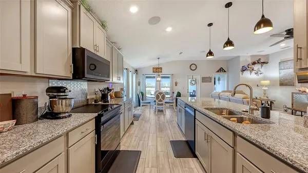 a kitchen with lots of counter space and stainless steel appliances