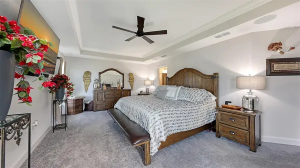 a bedroom with a bed and a chandelier
