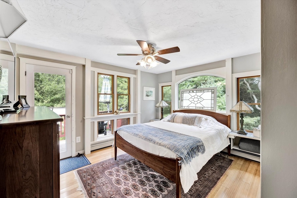 67 Cliff Road Bourne, MA 02532 - Photo 18 of 36 a bed sitting in a bedroom next to a window