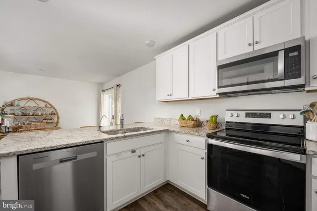 wooden floor with a mirror and a dresser