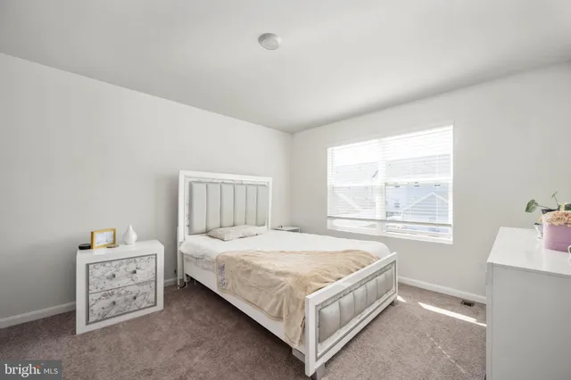 a white toilet sitting next to a white tub