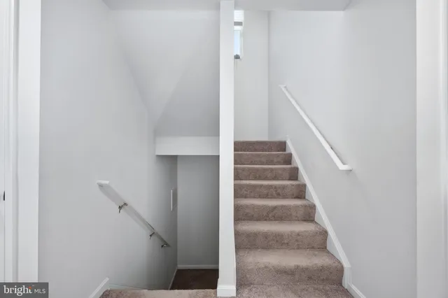 a refrigerator in a kitchen and a window
