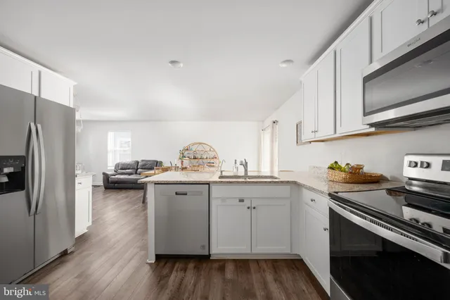 a living room with fireplace furniture and a window