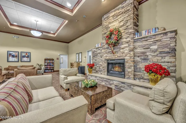a living room with furniture and a ceiling fan