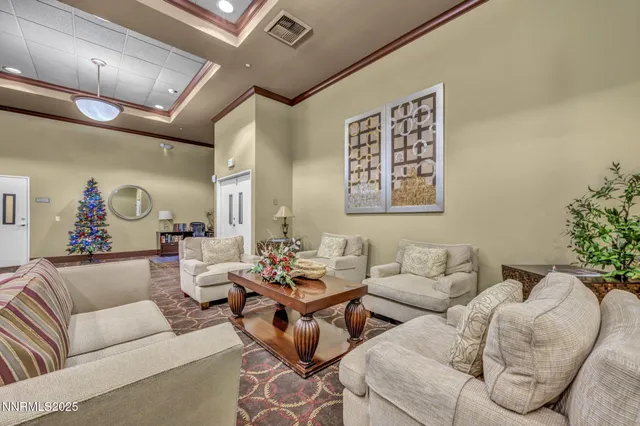 a living room with lots of furniture and view of kitchen