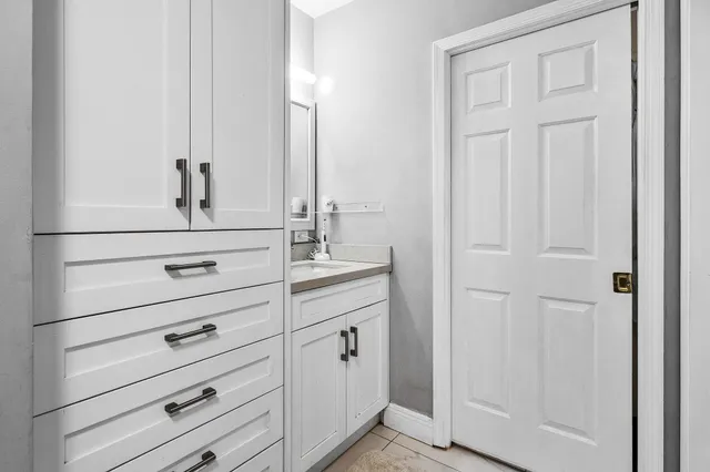 a view of a patio with table and chairs and potted plants