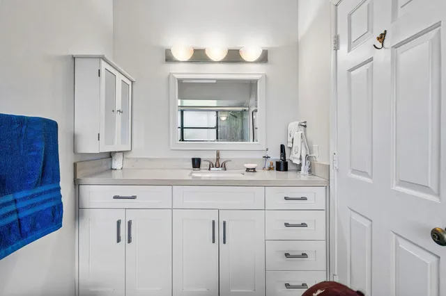 a view of an chairs and table in patio with a lake view