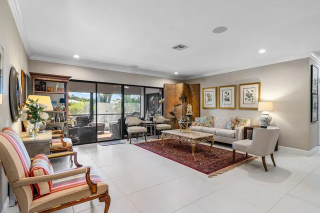 a living room with furniture rug and a window