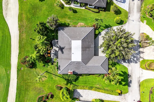 a view of a house with a yard and potted plants