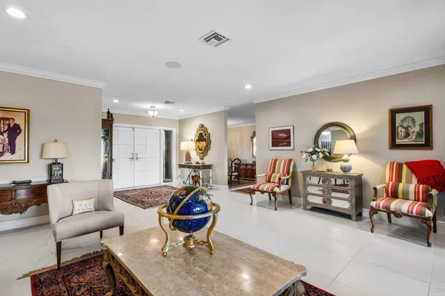 a living room with furniture ceiling fan and a window