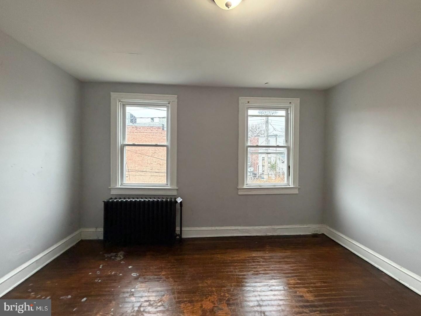 2606 Beryl Avenue Baltimore, MD 21205 - Photo 16 of 39 a view of an empty room with wooden floor and a window