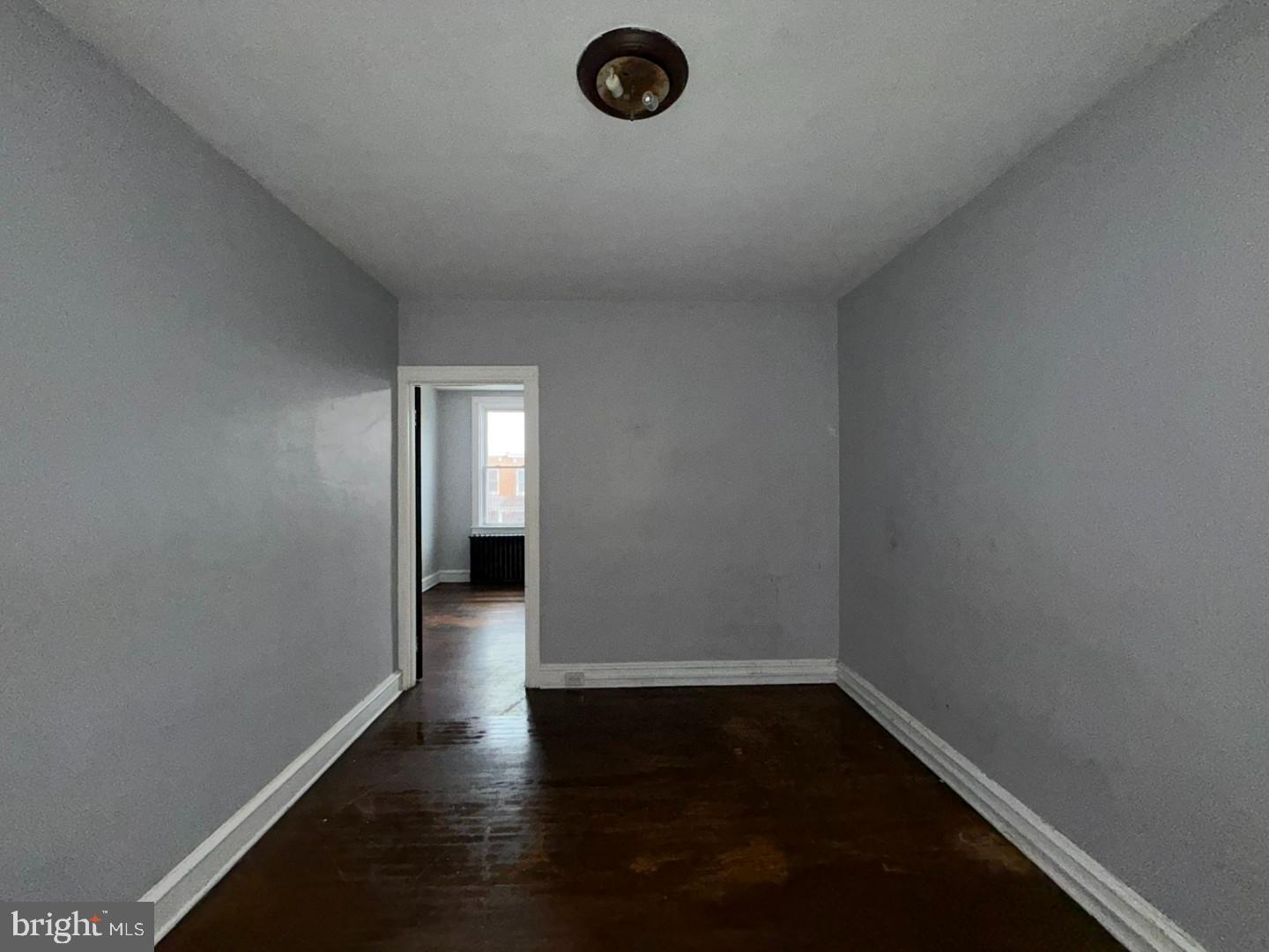 2606 Beryl Avenue Baltimore, MD 21205 - Photo 21 of 39 an empty room with wooden floor and windows